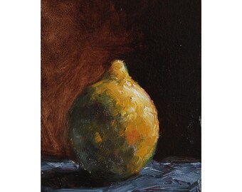 May include: A single, yellow-green lemon with a slightly bumpy texture sits on a blue surface against a dark brown background.