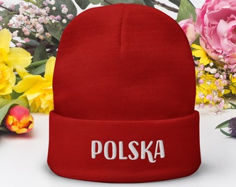 Puede incluir: Gorro rojo con la palabra "POLSKA" bordada en blanco en el puño.