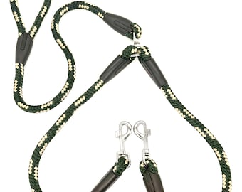 May include: A green and cream rope dog leash with two metal clips. The leash is designed for walking two dogs.