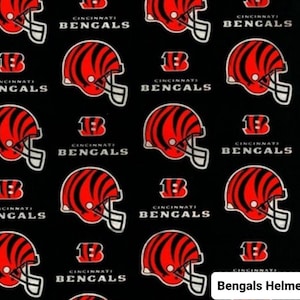 May include: Black fabric with a repeating pattern of red and black Cincinnati Bengals helmets and the words "Cincinnati Bengals".