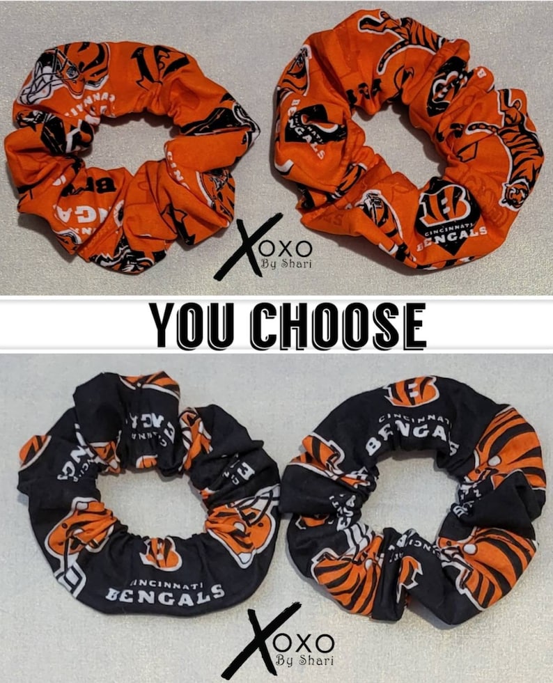 May include: Two orange and black scrunchies with the Cincinnati Bengals logo and tiger stripes. The scrunchies are made of fabric and have a stretchy elastic band.