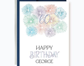 May include: A white card with a colorful firework design and the text "Happy Birthday George" in black.