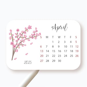 May include: A white calendar with a pink cherry blossom design. The calendar is for April 2025.