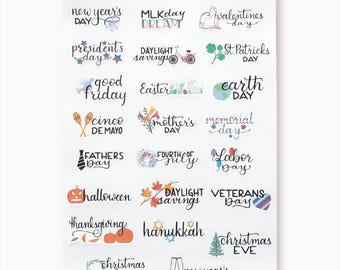 May include: A set of 18 colorful stickers featuring various holidays and events throughout the year. The stickers are designed with handwritten text and illustrations. The text includes "New Year's Day", "MLK Day", "Valentine's Day", "President's Day", "Daylight Savings", "St. Patrick's Day", "Good Friday", "Easter", "Earth Day", "Cinco de Mayo", "Mother's Day", "Memorial Day", "Father's Day", "Fourth of July", "Labor Day", "Halloween", "Daylight Savings", "Veterans Day", "Thanksgiving", "Hanukkah", "Christmas Eve", "Christmas Day", and "New Year's Eve".