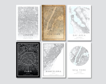 May include: Six framed city map prints. The maps include London, New York, Bay Area, Paris, Barcelona, and New York. Each map is a detailed, grayscale representation of the city's layout, with the city name and coordinates displayed below.