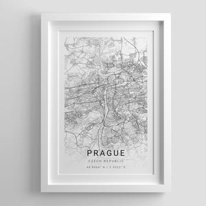 May include: A framed wall art print featuring a black and white map of Prague, Czech Republic. The map displays intricate street networks and a river, with the text PRAGUE, CZECH REPUBLIC, and the coordinates 48.8566 N / 2.3522 E printed below.