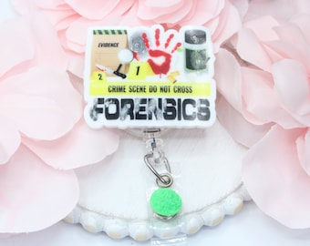 Può includere: Un porta badge a tema forense su sfondo bianco. Il porta badge presenta un design della scena del crimine con le parole "CRIME SCENE DO NOT CROSS" e "FORENSICS". Il design include un'impronta della mano, indicatori di prove e altri elementi della scena del crimine.