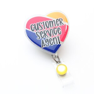 May include: A heart-shaped badge holder with a red, blue, and yellow design. The badge holder has the text "Customer Service Agent" printed on it.