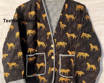 May include: A black quilted jacket with a leopard print and a white and black striped lining. The jacket has a button closure and two pockets.