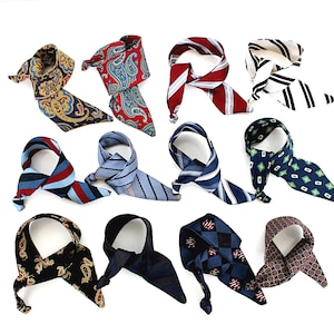 Könnte beinhalten: Eine Sammlung gemusterter Halstücher in verschiedenen Designs und Farben. Die Tücher weisen Paisley-, Streifen- und geometrische Muster in Blau-, Rot-, Schwarz- und Brauntönen auf. Die Tücher sind auf weißem Hintergrund angeordnet.