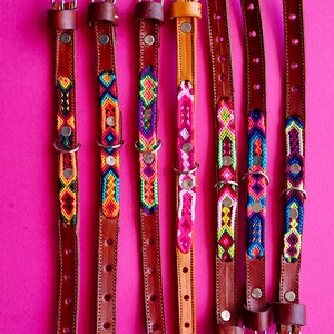 May include: Seven leather dog collars with colourful woven patterns. The collars are numbered 1 through 7.