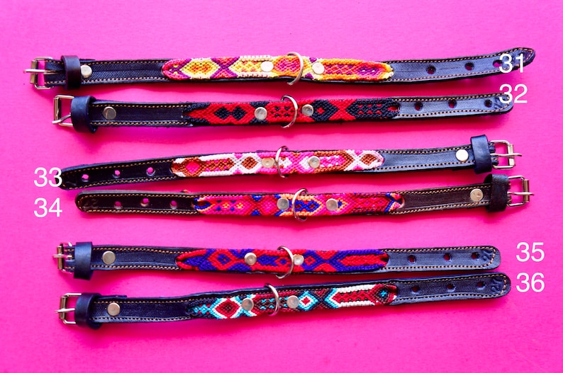 May include: Five colourful dog collars with leather straps and metal buckles. The collars feature a variety of woven patterns in red, blue, yellow, white and black.
