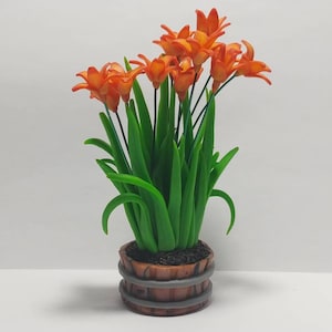 May include: A small potted plant with orange flowers and green leaves. The plant is in a brown and grey pot with a wood-like texture.