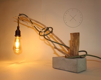 Natural wood branch and concrete table lamp