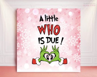 May include: A pink and white Christmas-themed print with the text "A little WHO is DUE!" in black and red. The image features green hands forming a heart with baby footprints.
