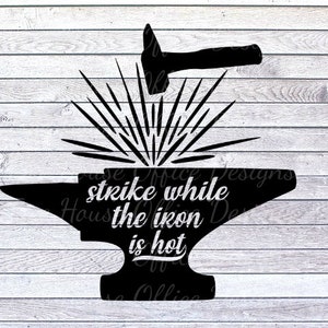 May include: Black silhouette of a hammer striking an anvil, with radiating lines suggesting sparks. The text "strike while the iron is hot" is centered on the anvil. The background is a white wood grain pattern.