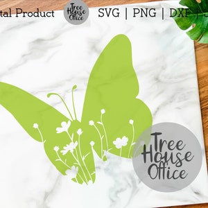 May include: Green butterfly silhouette with white flowers and stems inside the wings. The butterfly is on a white marble background with a gray circle that says "Tree House Office" in black text.