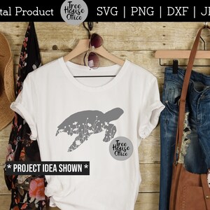 Turtle silhouette with wildflowers inside SVG design shown applied to a white shirt as a project idea