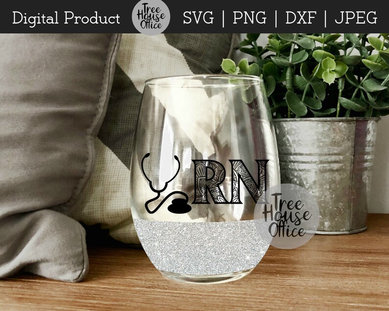 May include: A clear glass wine glass with a silver glitter design at the bottom. The glass has a black and white design of a stethoscope and the letters "RN" with a decorative pattern. The text "Tree House Office" is visible on the glass.