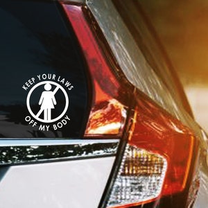 May include: White vinyl car decal with the text "KEEP YOUR LAWS OFF MY BODY" in a circular design. The design includes a silhouette of a person with an arm raised, inside a circle.