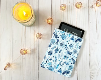 May include: A blue and white patterned e-reader sleeve with a variety of mystical symbols and the word "Chapter" displayed on the e-reader screen.