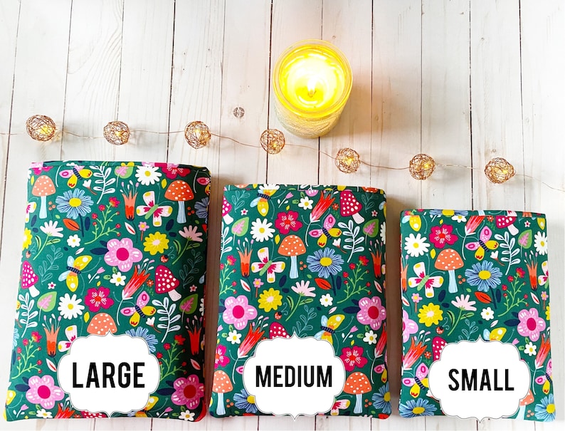 May include: Three green fabric zippered pouches with a floral and mushroom print. The pouches are labeled "LARGE", "MEDIUM", and "SMALL".