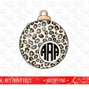May include: A round Christmas ornament with a leopard print design. The ornament features a gold-colored top and a white circle in the center with the letters "AAA" in a black, bold font. The background is white with a repeating pattern.