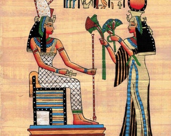 May include: A hand-painted papyrus scroll depicting two Egyptian goddesses. The goddess on the left is seated on a throne and holds a staff. The goddess on the right is standing and offering a bouquet of lotus flowers. The scroll is decorated with hieroglyphs and a border of gold.