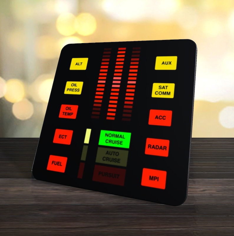 May include: A black dashboard with red and green lights, labeled with text like "ALT", "AUX", "OIL PRESS", "SAT COMM", "OIL TEMP", "ACC", "ECT", "NORMAL CRUISE", "AUTO CRUISE", "PURSUIT", "RADAR", "FUEL", and "MPI".