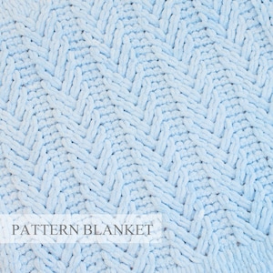 May include: A light blue knitted blanket featuring a textured herringbone pattern. The surface displays a consistent weave of soft, plush yarn loops. The text PATTERN BLANKET is printed in a white rectangular overlay at the bottom left corner.