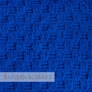 May include: A vibrant royal blue blanket featuring a textured, raised basketweave pattern. The fabric displays a repeating grid of vertical and horizontal woven segments. The text "PATTERN BLANKET" is overlaid in a light, semi-transparent font.