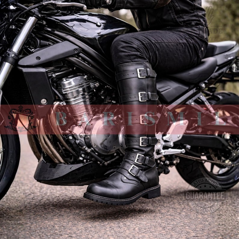 May include: Black leather motorcycle boots with multiple silver buckles. The boots are knee-high and have a rugged sole. The image shows the boots on a motorcycle, suggesting a biker or motorcycle enthusiast theme.