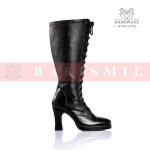 May include: A black knee-high boot with a lace-up design and a high heel. The boot has a rounded toe and a platform sole. The image is set against a white background.