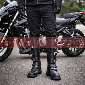 May include: Black leather knee-high boots with multiple silver buckles. The boots have a brown leather band at the top. The boots are worn with black jeans. A black motorcycle is in the background.