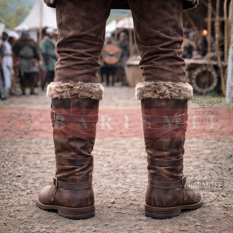 May include: Brown leather knee-high boots with fur trim. The boots feature buckle closures and crisscross straps. The image shows the back view of the boots, with a blurred background of people and buildings.