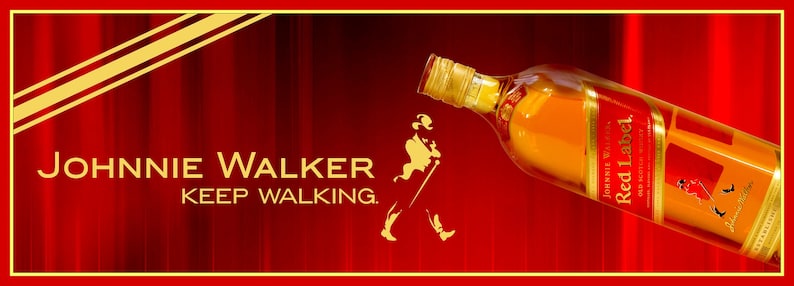 May include: A red and gold Johnnie Walker Red Label Scotch Whisky bottle with the slogan "Keep Walking." The bottle is tilted and the label is visible.