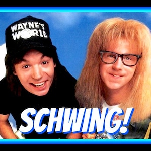 May include: Two men, one wearing a black baseball cap with the text "Wayne's World" and the other with long blonde hair and glasses, are smiling and looking at the camera. The text "SCHWING!" is in large, bold letters in front of them.
