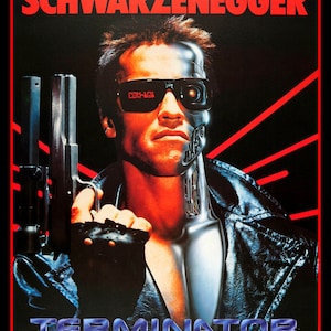 May include: A movie poster for the film Terminator, featuring Arnold Schwarzenegger as the Terminator. The poster has a black background with red and white accents. The text "Schwarzenegger" is at the top of the poster, and the text "Terminator" is at the bottom. The Terminator is holding a gun in his right hand.