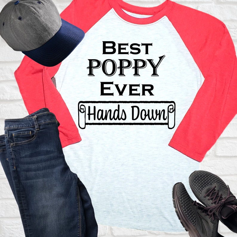 May include: A white and red baseball tee shirt with the text "Best Poppy Ever Hands Down" printed on the front. The shirt has a red sleeve and a white sleeve.