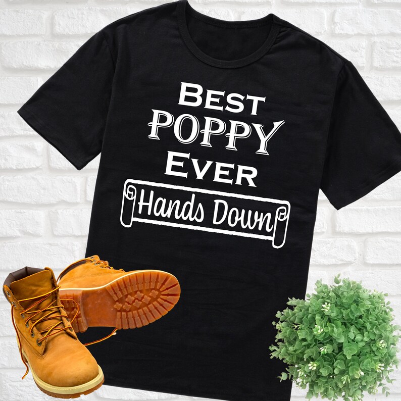 May include: Black t-shirt with white text that reads "Best Poppy Ever Hands Down".