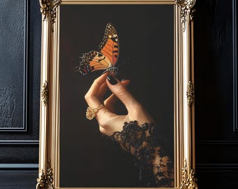 May include: A gold-framed picture with a dark background featuring a hand wearing a black lace glove holding a butterfly with orange and black wings.