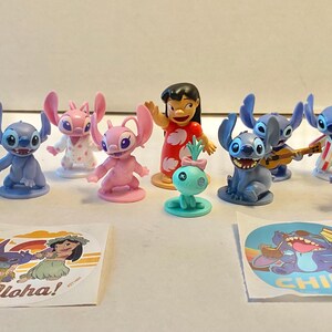 May include: A collection of 10 small plastic figurines of Stitch and his friends from the Disney movie Lilo & Stitch. The figurines are in various poses and include Stitch, Angel, Jumba, and Lilo. There are also two stickers with the words "Aloha!" and "Chill" on them.