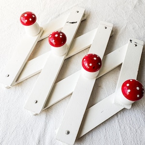 May include: A white ceramic mug with a black handle and the text "But First, Coffee" in a black, bold font. The mug is on a white surface.