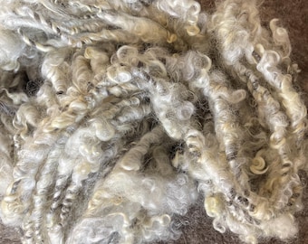 Hand Spun Art Yarn. The core is Yak/Merino blend. The curls are Gotland Wool