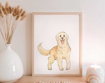 May include: A framed watercolor print of a Golden Retriever dog. The dog is depicted in a standing pose with a happy expression. The artwork is displayed on a wooden surface, alongside a white vase with dried flowers and a decorative candle.