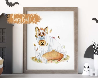 Puede incluir: Una ilustración de acuarela de un zorro con un disfraz de fantasma con una cara de calabaza. El zorro está rodeado de hojas de otoño. La ilustración se titula "Ivory Owl Co."