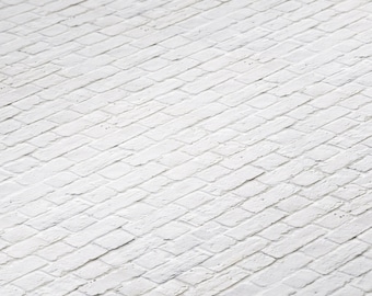 May include: White brick wall with a diagonal pattern. The bricks are arranged in a herringbone pattern.