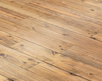 May include: A close-up of a light brown wood floor with a diagonal pattern. The wood has a natural grain and a slightly distressed look.
