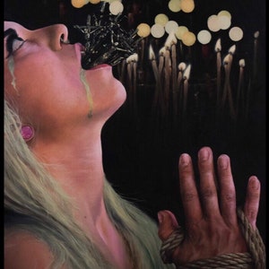 May include: A woman with blonde hair is shown with her mouth open and a dark, spiky object protruding from it. Her eyes are closed and she has a pained expression. Her right hand is tied with a thick rope. The background is dark with a blurred image of many lit candles.
