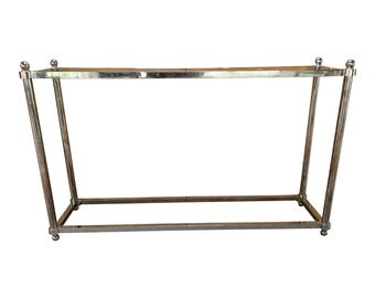 May include: A chrome console table with a rectangular top and a lower shelf. The table has a simple, modern design.
